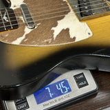 Used 2010 Rebel Relic T-Style Sunburst on scale displaying weight.