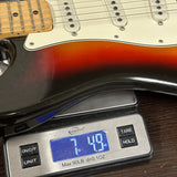 Vintage 1974 Fender Stratocaster Sunburst on scale displaying weight.