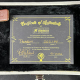 A black Certificate of Authenticity card with gold lettering and border details, placed on a black fur-lined case. The card is signed by Billy Reave and includes the Rock N' Roll Relics branding.