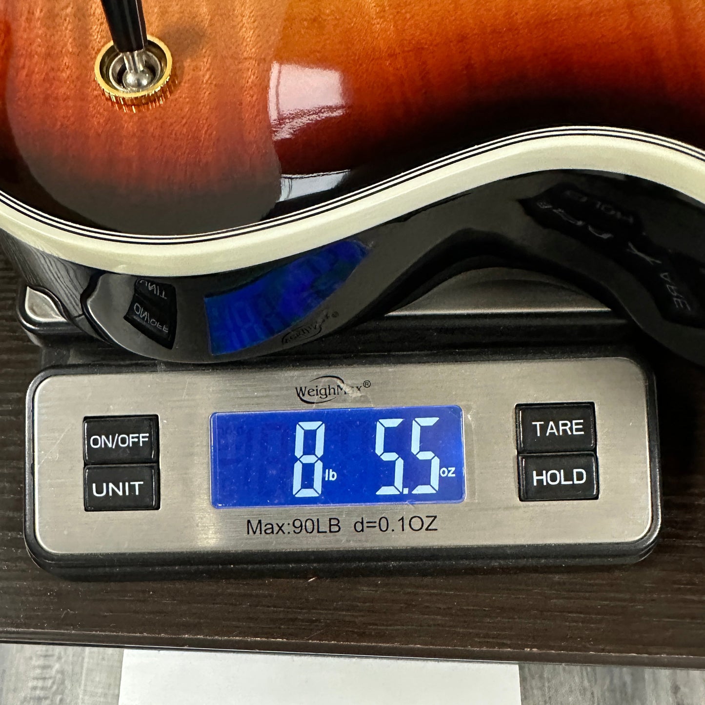 Used Gibson Les Paul Supreme Fireburst on a scale displaying the weight.