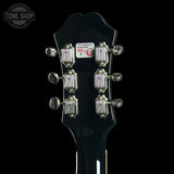 Guitar headstock with tuning pegs on a black background, featuring 'Tone Shop' logo.