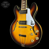 Electric guitar with a sunburst finish on a black background, featuring the 'Tone Shop' logo.