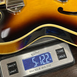 Guitar on a digital scale displaying weight