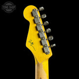 Close-up of a yellow guitar headstock with tuning pegs on a black background, featuring 'Tone Shop' branding.