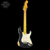 Electric guitar with a black pickguard and white neck on a black background, featuring 'Tone Shop' branding.