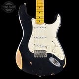 Black electric guitar with white pickguard on a black background, featuring 'Tone Shop' logo.