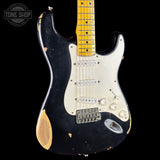 Black electric guitar with white pickguard on a black background, featuring 'Tone Shop' logo.