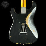 Black electric guitar with gold accents on a black background, featuring the Tone Shop logo.