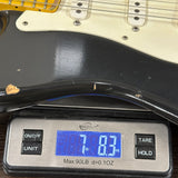 Guitar on a digital scale displaying weight