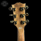 Close-up of the headstock of a Gibson electric guitar, showing the six tuning pegs, wood grain, serial number CS 601963, and Gibson logo against a black background.