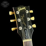 Gibson Les Paul Deluxe guitar headstock on a black background