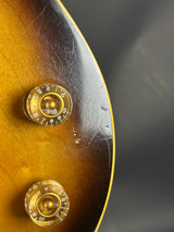 Close-up of a guitar's control knobs with a dark background