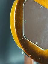 Close-up of a guitar's soundhole and wooden body