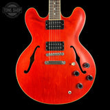 Red electric guitar with a black background