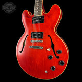 Red electric guitar with a black background