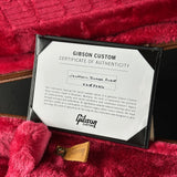 Gibson Custom Certificate of Authenticity on a red textured surface