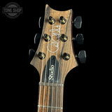 Guitar headstock with 'Studio' branding on a black background