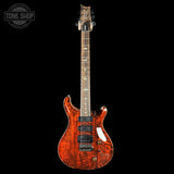Electric guitar with a wavy wood finish on a black background, featuring the Tone Shop logo.