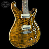 Wooden electric guitar with a visible brand logo on a black background