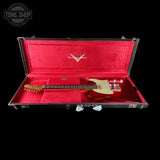 Red electric guitar in an open case with a visible brand logo on a black background.