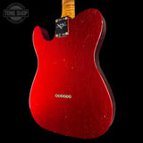 Red electric guitar body with 'Fender' branding on a black background