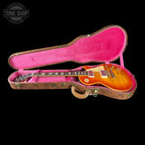 Gibson Les Paul guitar in a pink case with 'Tone Shop' logo.