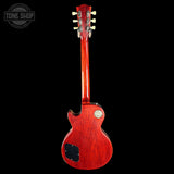 Red electric guitar on a black background with 'Tone Shop' logo.