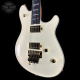 White electric guitar with gold hardware on a black background, featuring 'Tone Shop' logo.