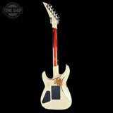 Worn electric guitar with visible wear on a black background, featuring the 'Tone Shop' logo.
