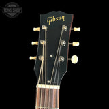 Gibson guitar headstock with brand logo on a black background