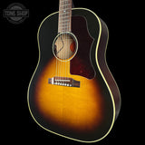 Acoustic guitar with a sunburst finish on a black background, featuring 'Tone Shop' branding.