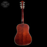 Back view of a wooden acoustic guitar with 'Tone Shop' logo in the corner.