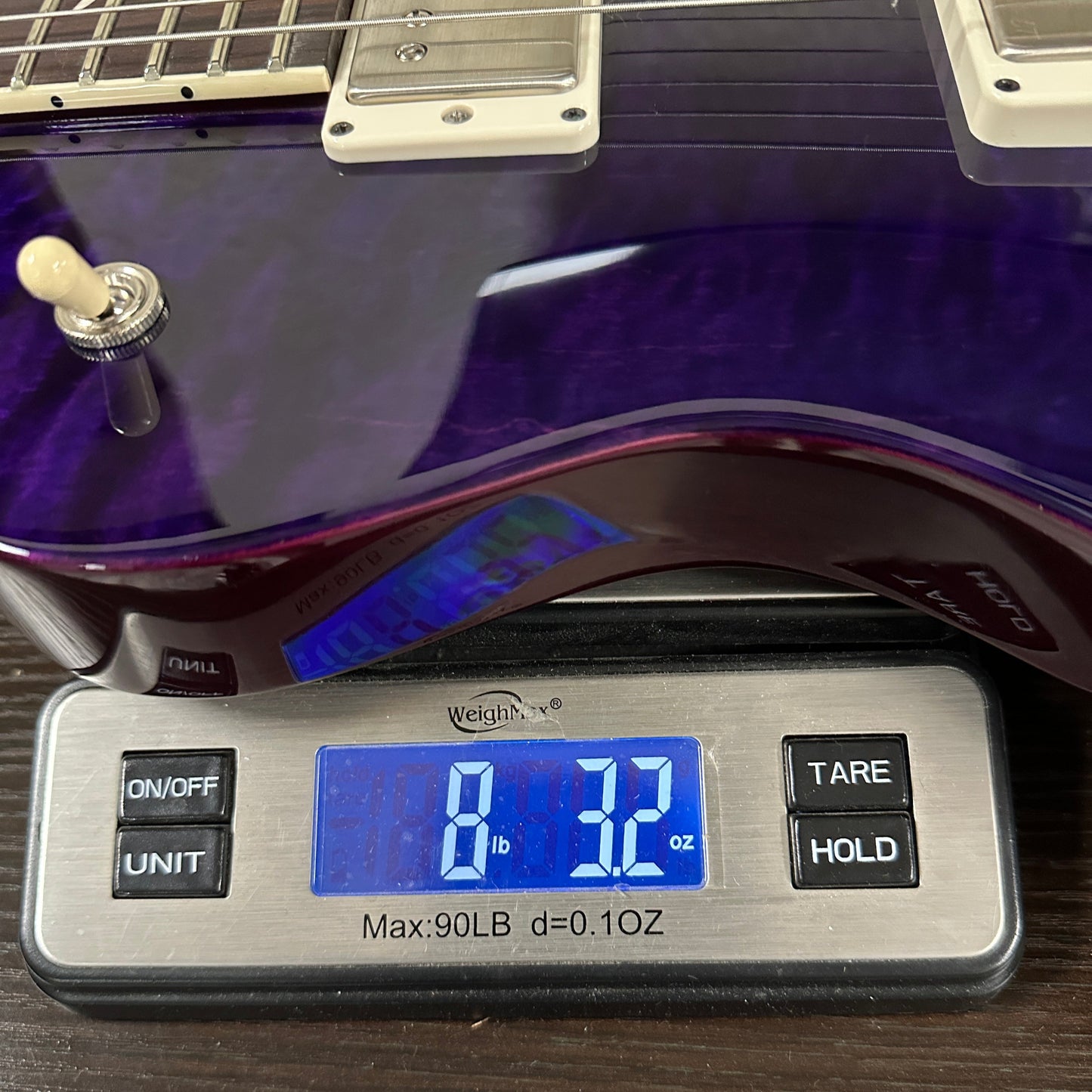 PRS S2 Wood Library McCarty 594 Singlecut Quilt Purple on scale displaying weight.