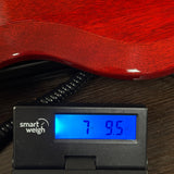 Used 2026 Gibson SG Standard 61 Maestro Vibrola Vintage Cherry on scale displaying weight.