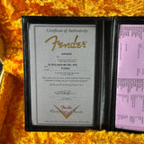 Fender certificate of authenticity on a yellow textured surface