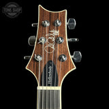 Guitar headstock with 'Tone Shop' logo in the corner