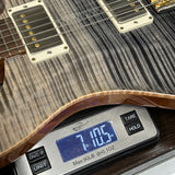 Used PRS TSG Anniversary Wood Library Artist DGT Frostbite Brazilian Rosewood on scale displaying weight.