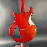 Red electric guitar on a gray background