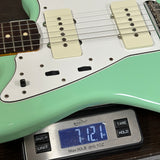 Used 2016 Fender Classic 60s Jazzmaster Lacquer Surf Green on scale displaying weight.