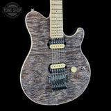 A custom electric guitar with a flamed maple top, featuring a dark brown and black wood grain finish, a light maple neck, and gold hardware, shown against a solid black background.