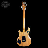 A natural wood electric guitar shown from the back against a solid black background, with a Tone Shop watermark in the top-left corner.