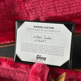 Gibson Custom Certificate of Authenticity card for a Southern Jumbo instrument, displayed in a black frame on a red velvet surface.