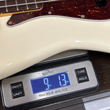 Used 2023 Fender American Pro II Jazz Bass White on scale displaying weight.