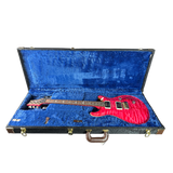 Red electric guitar in a blue-lined case on a white background