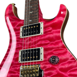 Close-up of a red electric guitar with a white pickguard on a white background