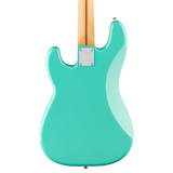 The rear view of an electric guitar with a glossy mint green body and a natural wood neck, isolated on a white background.