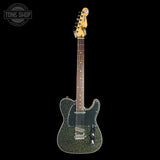 Electric guitar with a textured body on a black background, featuring the Tone Shop logo.