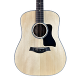 Acoustic guitar with a light wood finish on a white background