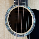 Close-up of an acoustic guitar's soundhole with decorative inlay
