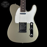 Electric guitar with a silver finish on a black background, featuring the Tone Shop logo.